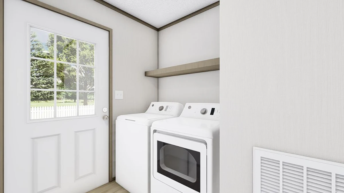 A laundry room with a door to the outside, featuring a white washing machine and dryer beneath a wooden shelf.