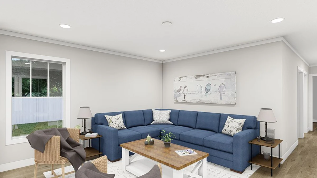A living room with a blue sectional sofa, wooden coffee table, two wicker chairs, side tables with lamps, and wall art depicting birds. A window lets in natural light.