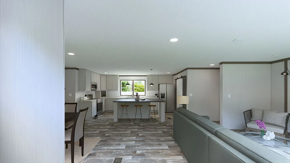 Open-concept kitchen and living room with gray cabinets, a center island with barstools, dining area, and modern furnishings. Large window provides natural light.