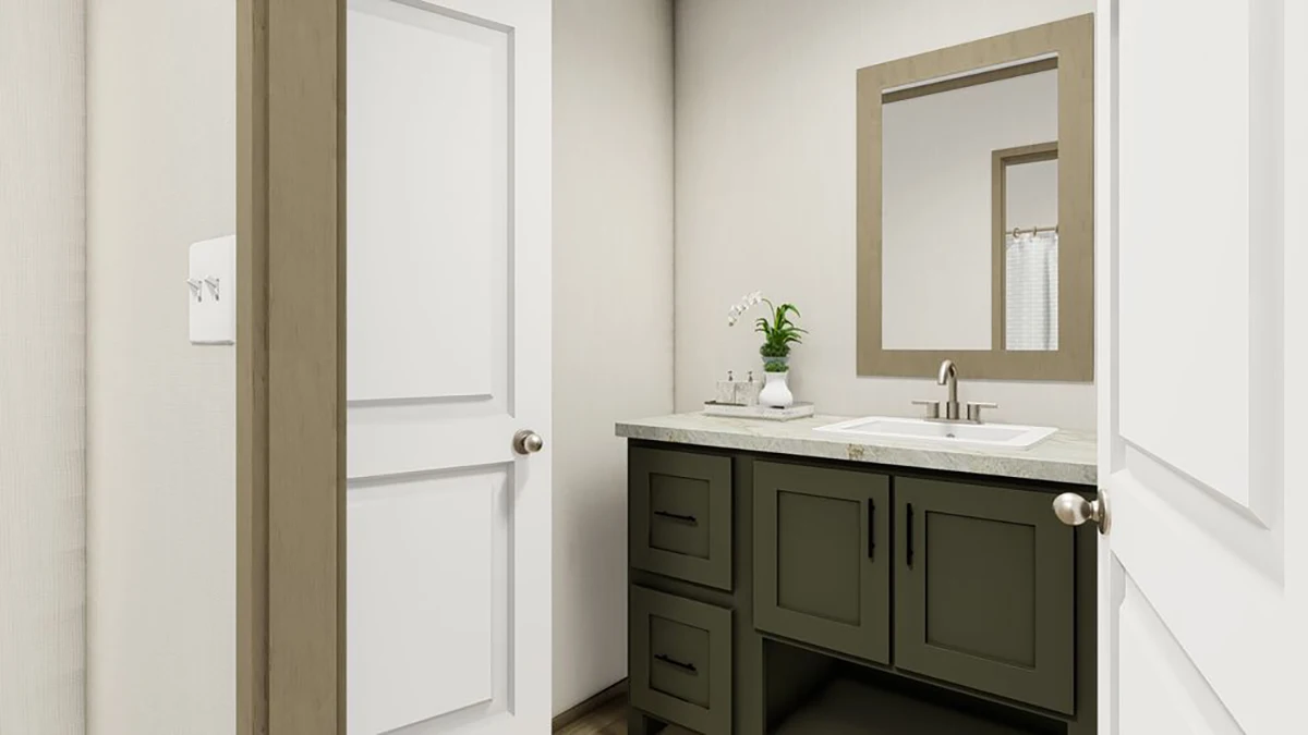 31babe09-8249-479a-a723-9efb8c12e48e A small bathroom with a dark green vanity, rectangular mirror, white countertop, sink, and a potted plant. Two doors are partially open.