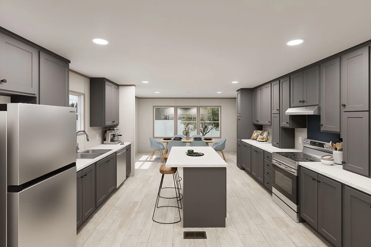 Modern kitchen with gray cabinets, stainless steel appliances, a large island with two stools, and a dining area by large windows in the background.