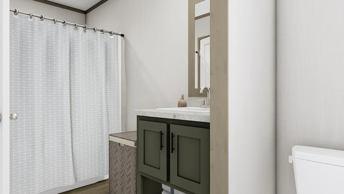 A bathroom with a white shower curtain, a green vanity with a sink and mirror, a woven hamper, and a white toilet.