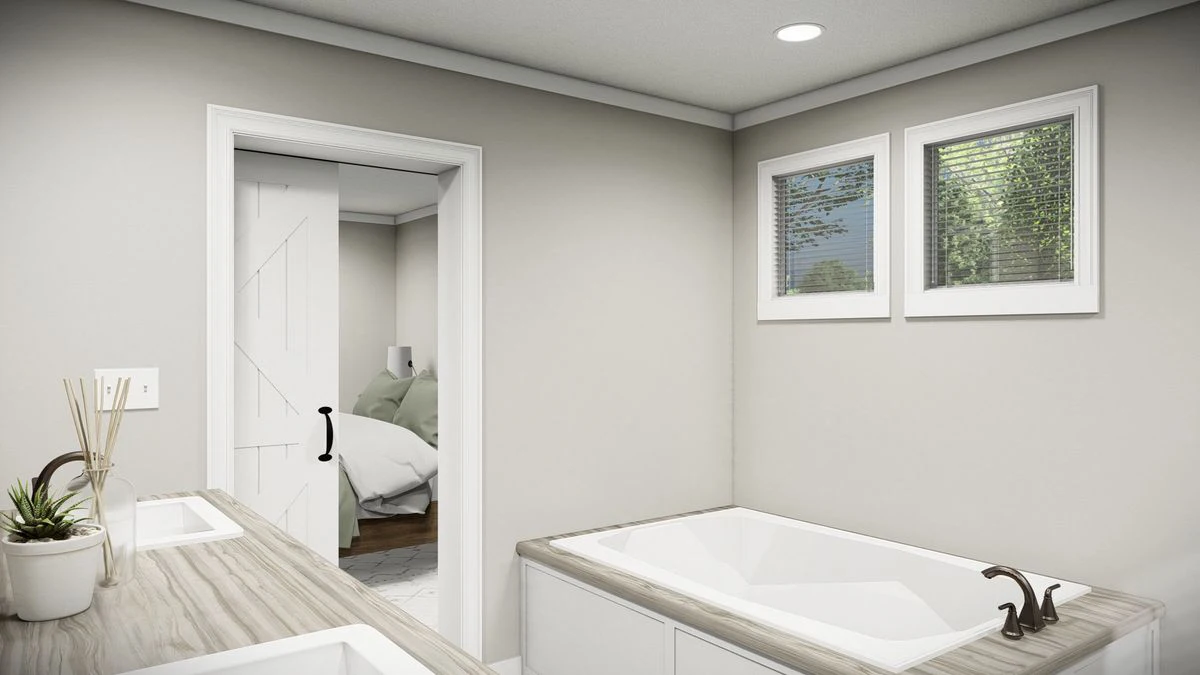 3f272b54-3bf2-421b-aef5-00fa956c014b Modern bathroom with a bathtub, double sink vanity, potted plant, and two windows; a door leads to a bedroom with a visible bed.