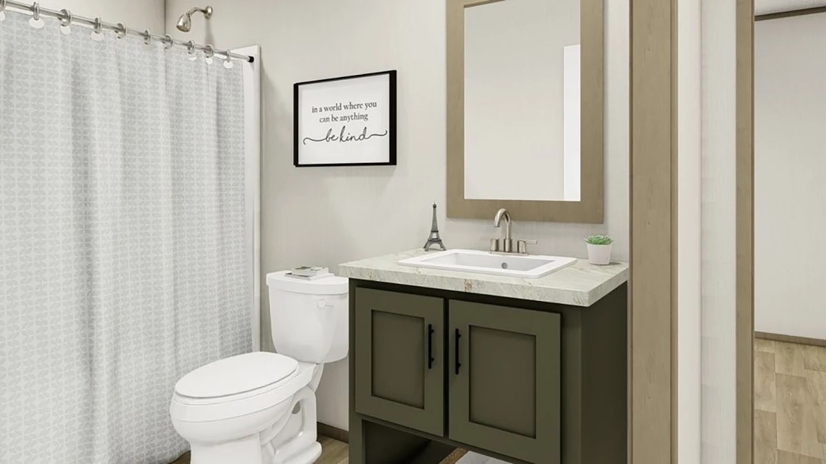 Modern bathroom with a shower and curtain, white toilet, olive green vanity with sink, rectangular mirror, and framed wall art above the toilet.