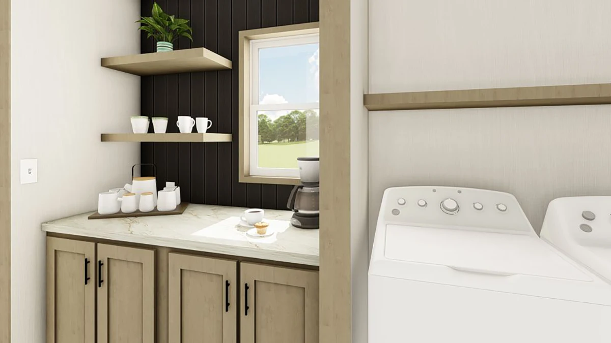 A laundry room with wooden cabinets, floating shelves holding cups and a plant, a coffee maker, a washer and dryer, and a window with a view of greenery.