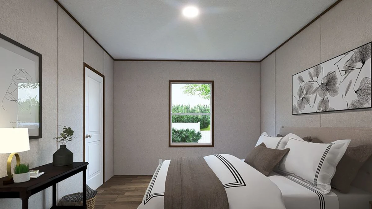 400cc75b-3c50-4af6-82e3-93119a44563d A small bedroom with a bed, neutral bedding, a side table with a lamp, minimalist wall art, a window, and hardwood floors.