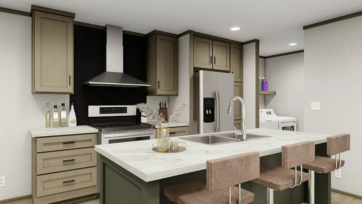 Modern kitchen with tan cabinets, stainless steel appliances, center island with sink and seating, and a visible laundry area with washer and dryer in the background.