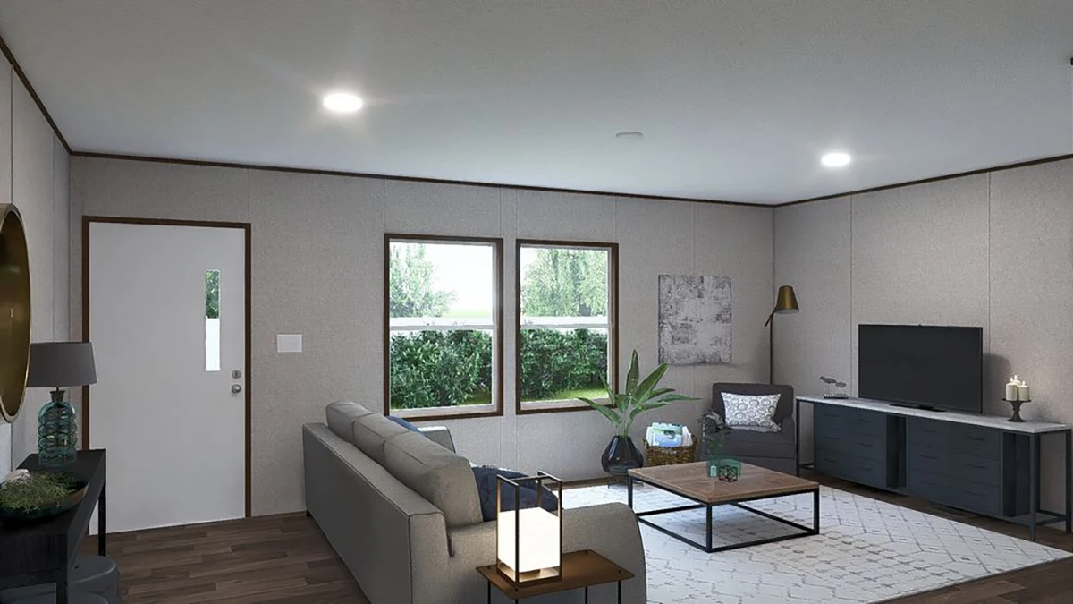 41d238fd-c14d-41fa-a5f1-7920ee539aca A modern living room with a grey sofa, coffee table, TV on a console, armchair, large window, potted plant, and neutral decor.