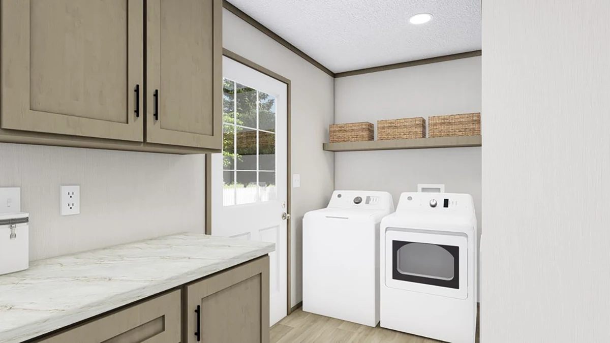 Laundry room with a washing machine and dryer side by side, a countertop, upper cabinets, a shelf with baskets, and a door with a window.