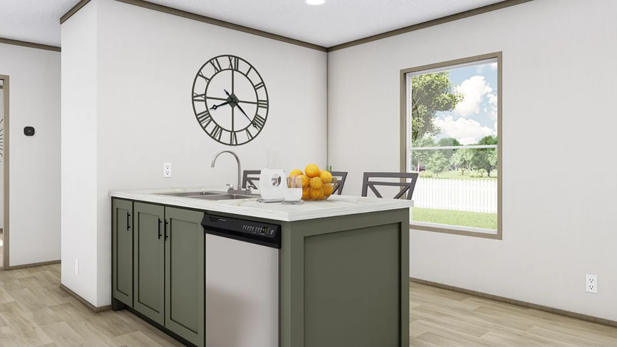 Modern kitchen with green island, stainless steel dishwasher, marble countertop, a bowl of oranges, a glass pitcher, and a large wall clock; window showing a yard outside.