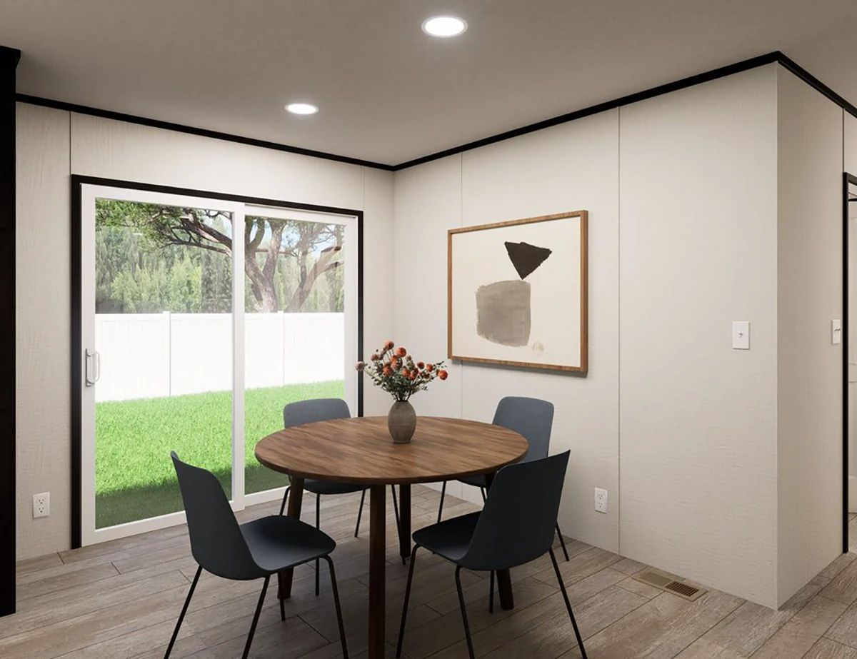 4e02e5e3-9386-4d61-8097-378f5ba8de7e A small dining area with a round wooden table, four black chairs, a vase of flowers, abstract wall art, and sliding glass doors leading to a green backyard.