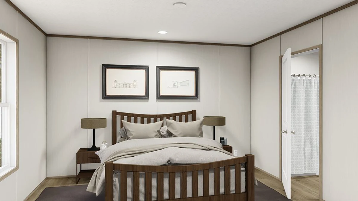 4f55fadd-f3f8-4b48-975b-21ef0c4efc7c A neatly made bed with wooden frame, two bedside tables with lamps, framed art above the bed, and an open door showing a bathroom with a shower curtain.