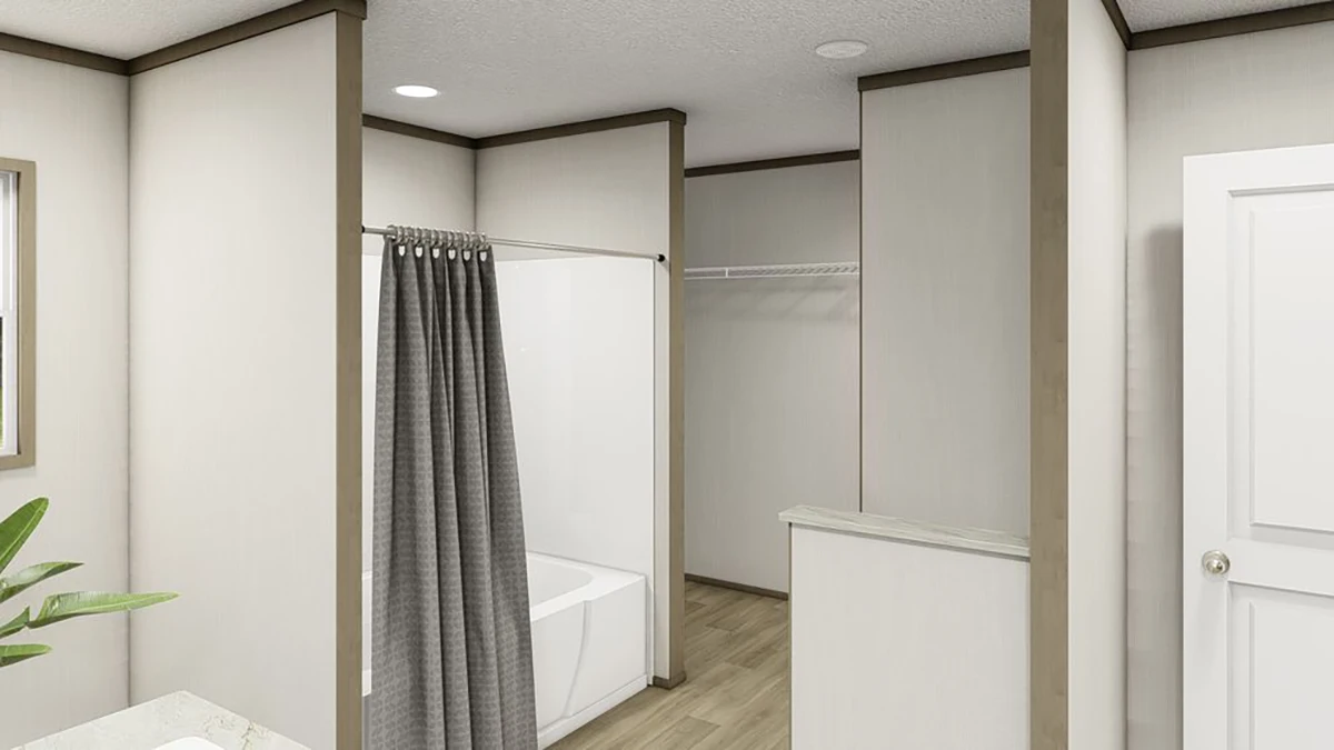 A bathroom with a bathtub and shower curtain on the left, open closet with wire shelf in the center, and a white door on the right. Light-colored walls and wood-style flooring.