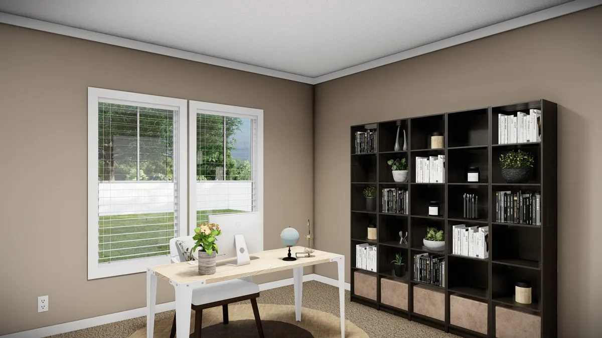 A home office with a desk, chair, globe, and laptop by a window; a large bookshelf filled with books and decor is against the adjacent wall.