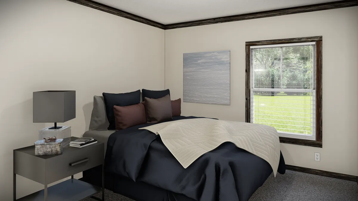547a41e3-55f1-4b87-824c-41856e76de6c A neatly made bed with dark bedding and a beige throw sits beside a window. A nightstand holds a lamp, books, and glasses. A painting hangs on the cream-colored wall.