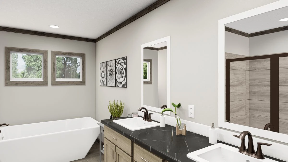 Modern bathroom with double sinks, a white bathtub, two mirrors, framed floral art on the wall, and wooden accents on the windows and vanity.