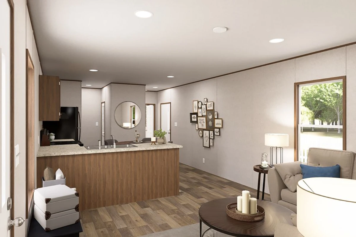 Modern open-plan kitchen and living room with wood accents, neutral walls, a round mirror, a photo gallery, and large windows offering garden views.