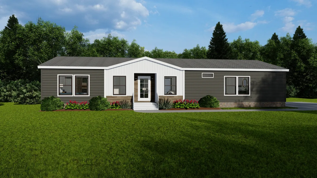 57faf04a-ab8a-4632-bb02-876f63db1368 A single-story manufactured home with dark siding, a white entrance, and a well-kept lawn, set against trees and a partly cloudy sky.