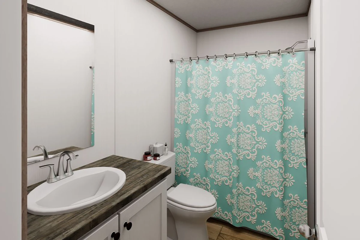 589bbb72-fcf9-492f-b4e9-60503731d410 Bathroom with a wood countertop, white sink, toilet, mirror, and a shower with a blue and white patterned curtain.