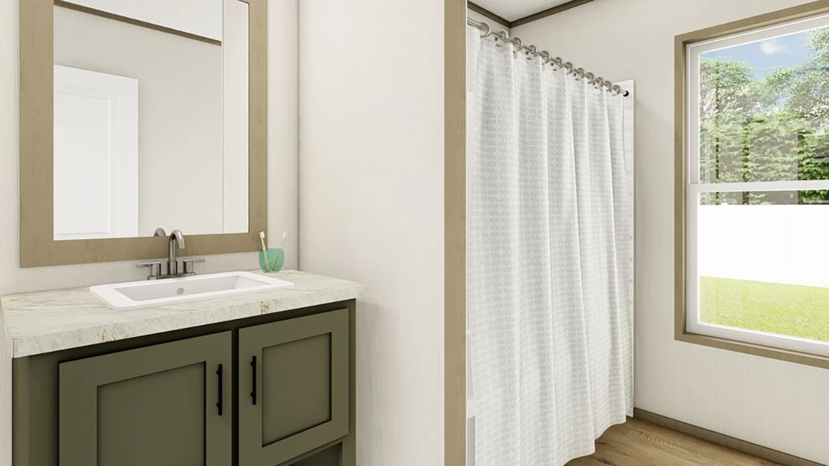 A bathroom with a green vanity, sink, mirror, toothbrush holder, shower with a white curtain, and a window showing greenery outside.