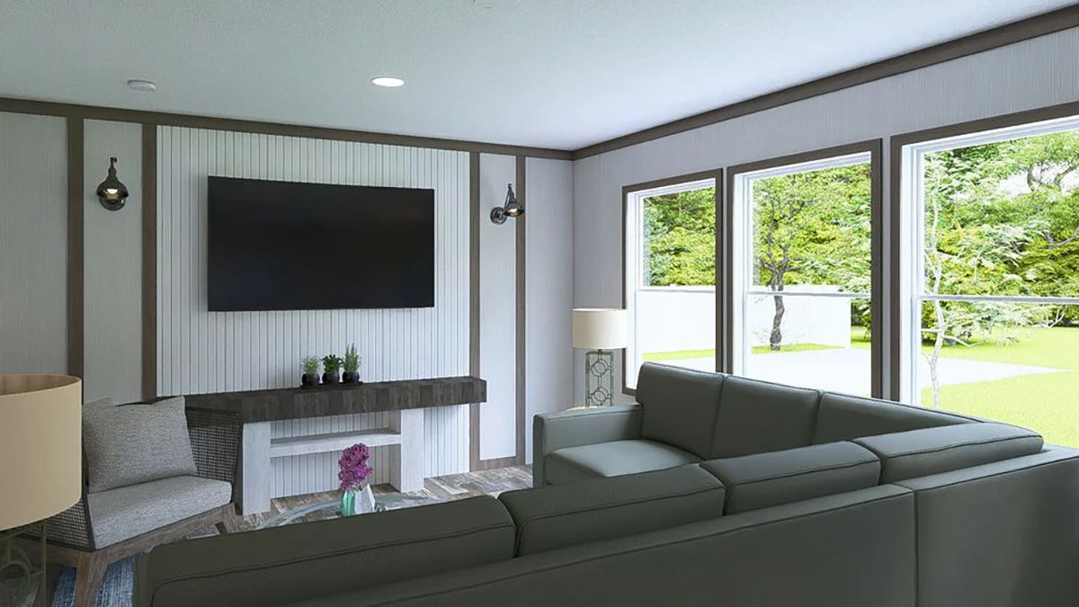 Modern living room with a sectional sofa, wall-mounted TV, two lamps, potted plants on a console, and large windows overlooking a green yard.