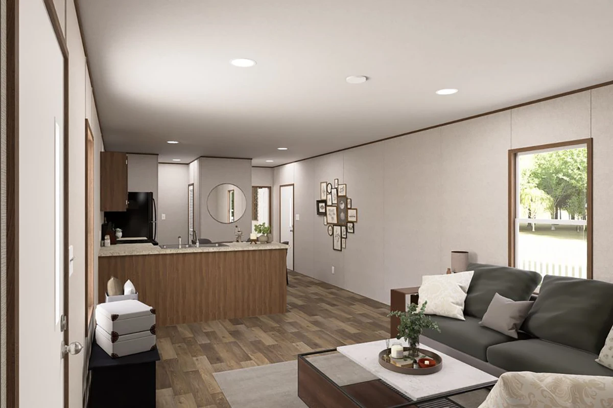 60df66d0-c7f4-469f-97c3-bd85686a7845 Open concept living room and kitchen with neutral decor, wood floors, a dark sofa, coffee table, and modern kitchen featuring wood cabinets and stainless steel appliances.