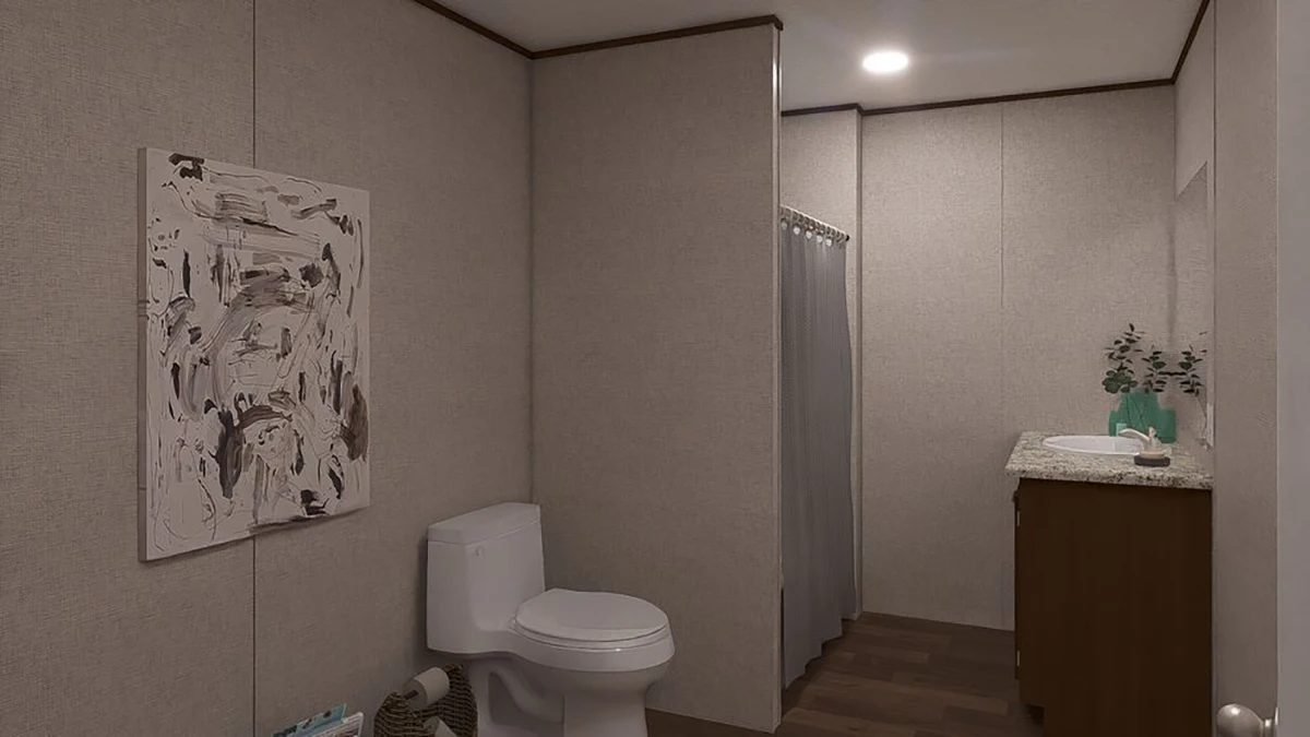 A bathroom with a toilet, abstract wall art, shower with a curtain, wooden vanity with sink, and a small plant on the countertop.