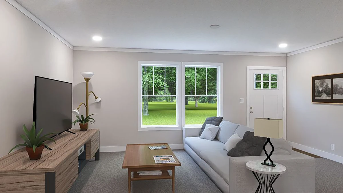 A living room with a gray sofa, coffee table, TV on a wooden stand, decorative plants, and a window showing a green outdoor view.