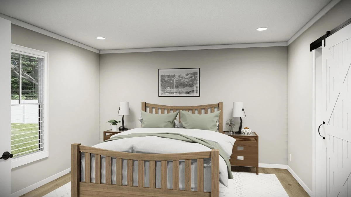 69909685-edb2-489c-914b-00e9e6aae821 A neatly made bed with green pillows and bedding sits between two wooden nightstands in a simple, modern bedroom with neutral walls and a barn-style door.