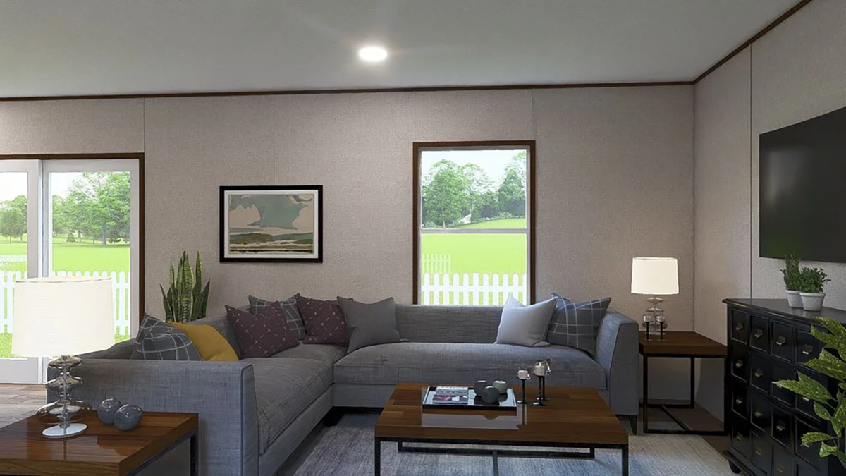 69d65965-f750-4f6b-ae97-bb44b776dcfe A modern living room with a gray sectional sofa, coffee table, side tables with lamps, wall art, indoor plants, and large windows showing a green yard with a white picket fence.