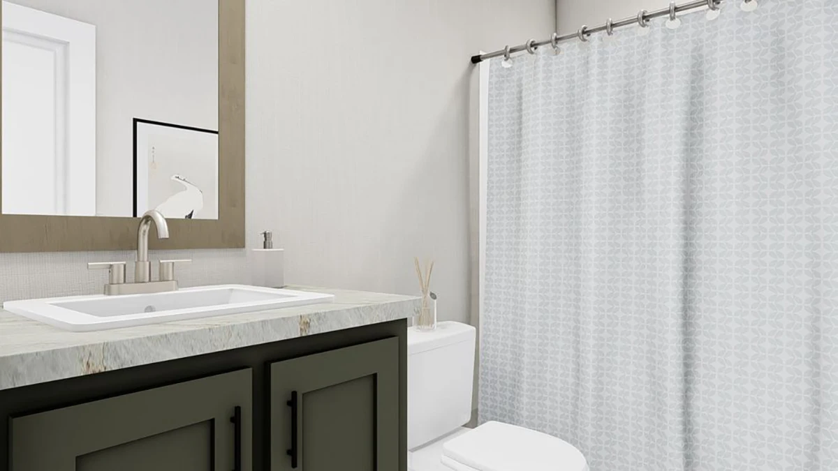 Modern bathroom with a white sink, dark green vanity, toilet, and a light grey patterned shower curtain on a rod.