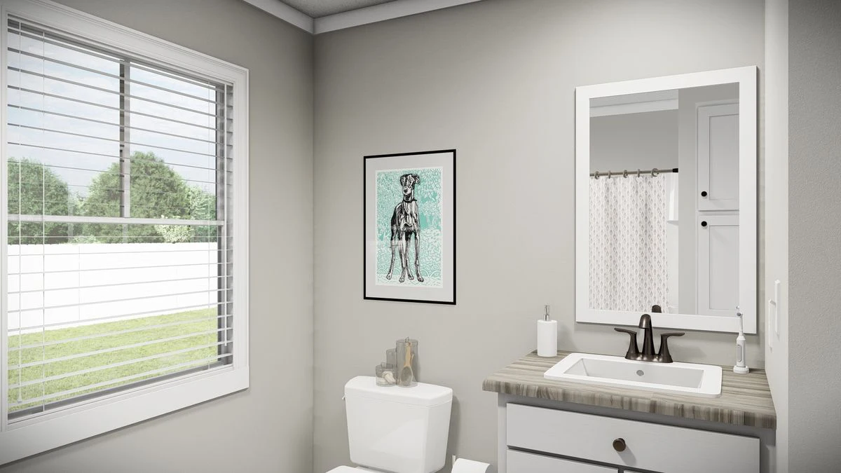6a4fb8d2-5e44-41d0-9061-9dde889aa505 A bathroom with a window, toilet, sink with a mirror, wall art above the toilet, and a shower curtain in the background.