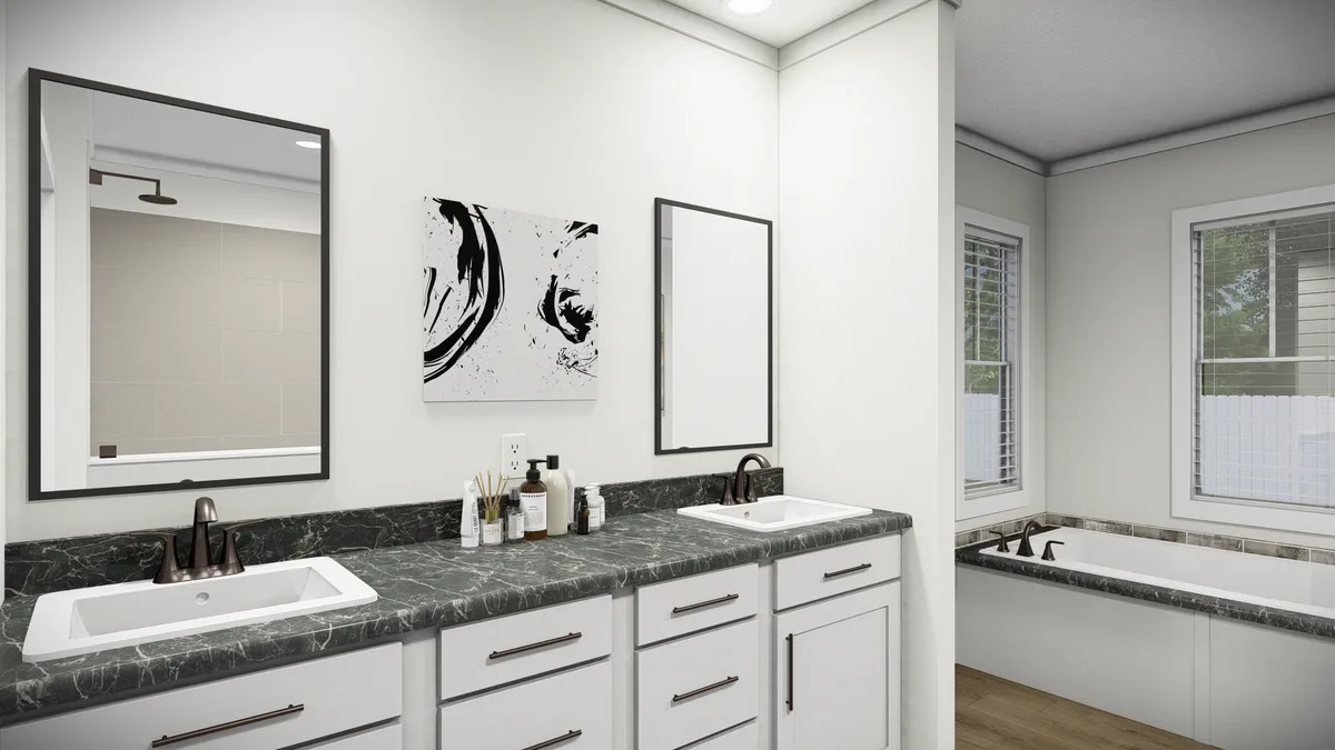 6e60c797-e1d1-4fe1-9e04-0f5b4112026f Modern bathroom with double sinks, black marble countertop, white cabinets, two mirrors, abstract wall art, and a built-in bathtub next to large windows with blinds.