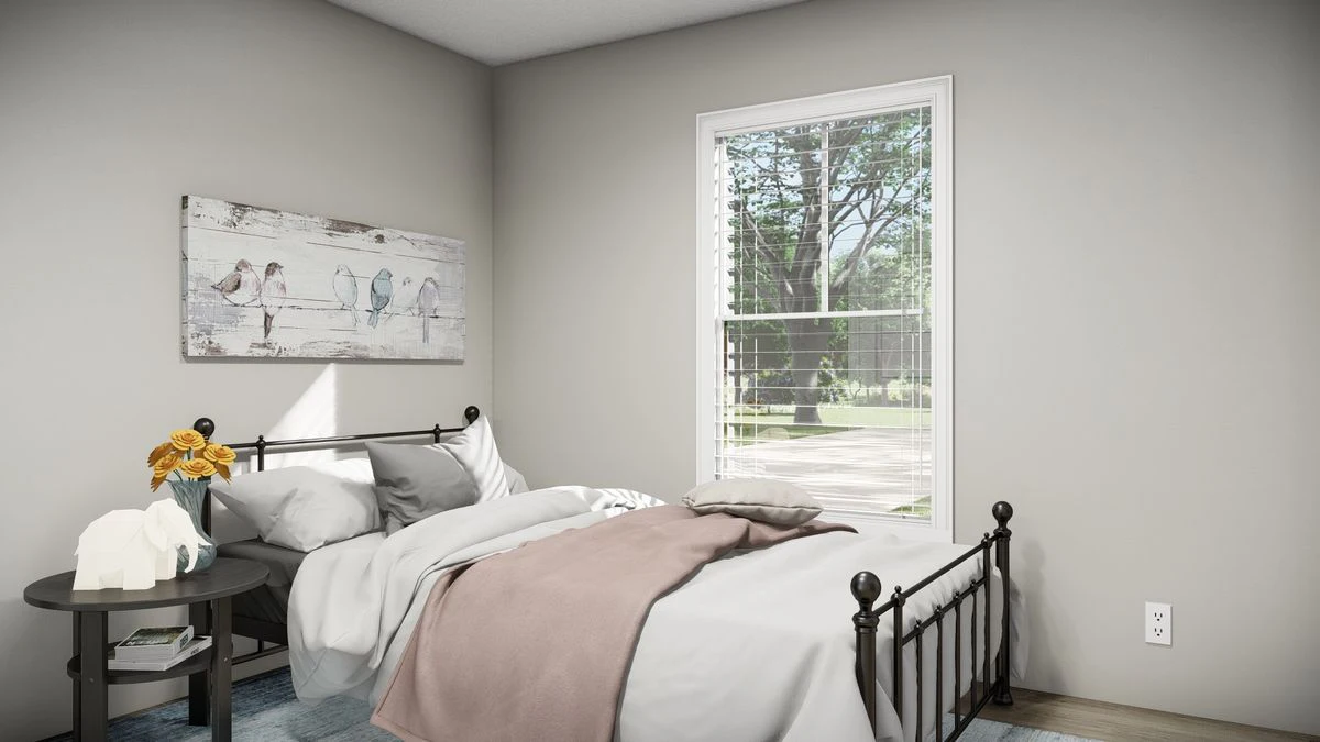 754bd48f-b6b6-4b34-9dbd-fe4b136b4e96 A small bedroom with a black metal bed, white and beige bedding, a round side table with flowers, wall art of birds, and a window with blinds showing trees outside.