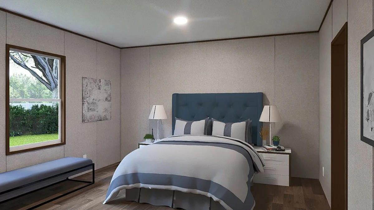 A modern bedroom with a blue upholstered bed, striped bedding, two white nightstands with lamps, a bench by the window, and neutral-colored walls.