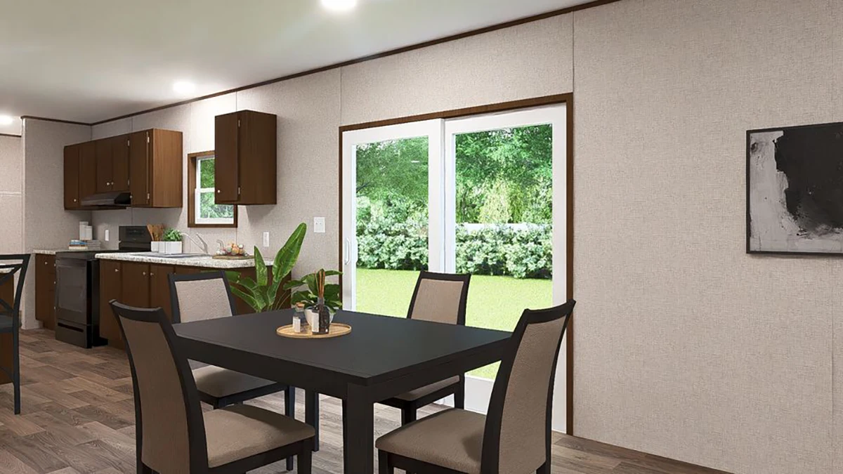 77e507c5-80f0-473b-a5bb-914f0653d2c2 A modern kitchen and dining area with a black table, four chairs, a potted plant, and glass doors leading to a green backyard.