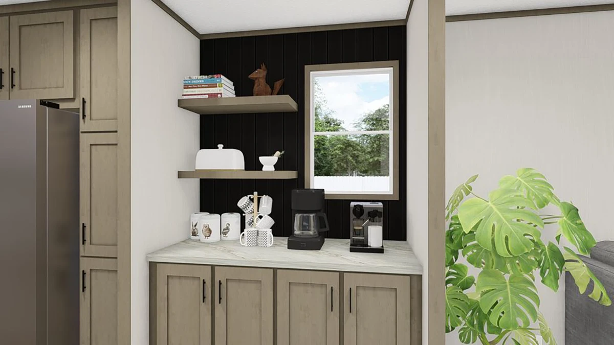 A small kitchen coffee station with a coffee maker, mugs, and decor on a marble countertop, shelves above, and a window in the background.