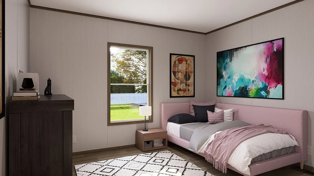 Modern bedroom with a pink bed, abstract wall art, a window showing a backyard, a nightstand with a lamp, and a patterned rug on a wooden floor.