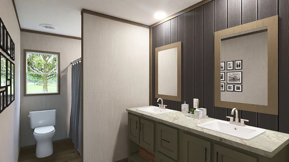 Modern bathroom with double sinks, a large mirror, and a separate area for the toilet and shower; neutral colors and framed photos on the wall.