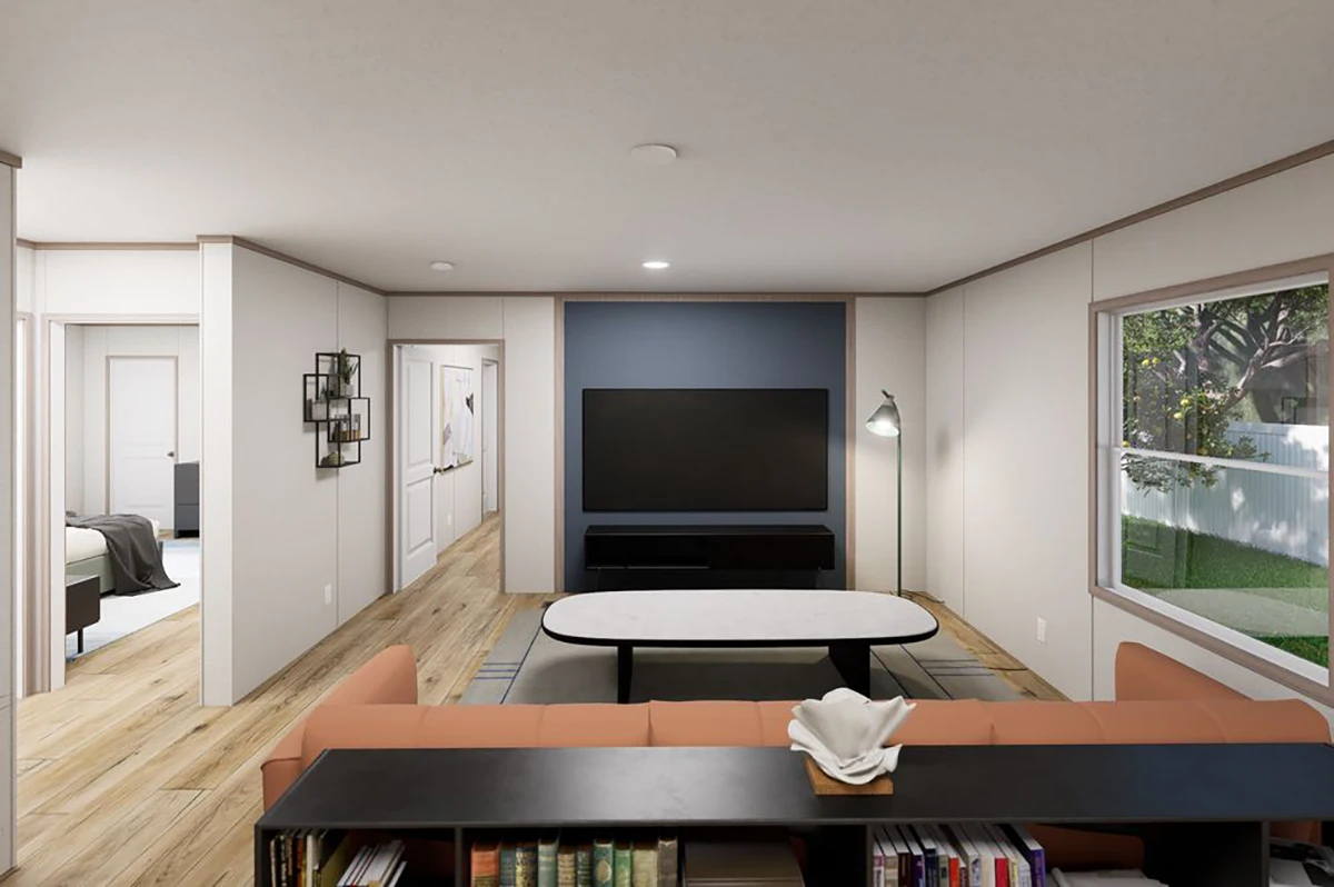 8093cc44-3ccd-43f0-99fd-28034e0ebc23 Modern living room with a sofa, coffee table, TV on a blue accent wall, floor lamp, and a large window showing a backyard with a fence and trees.