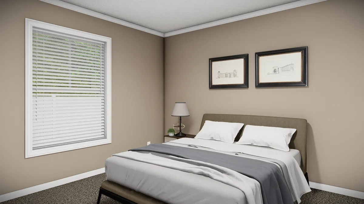 87a38edf-eb0a-456b-b6e3-9936820b2686 A simple bedroom with a bed, two pillows, a side table with a lamp, two framed pictures above the bed, beige walls, and a window with blinds.