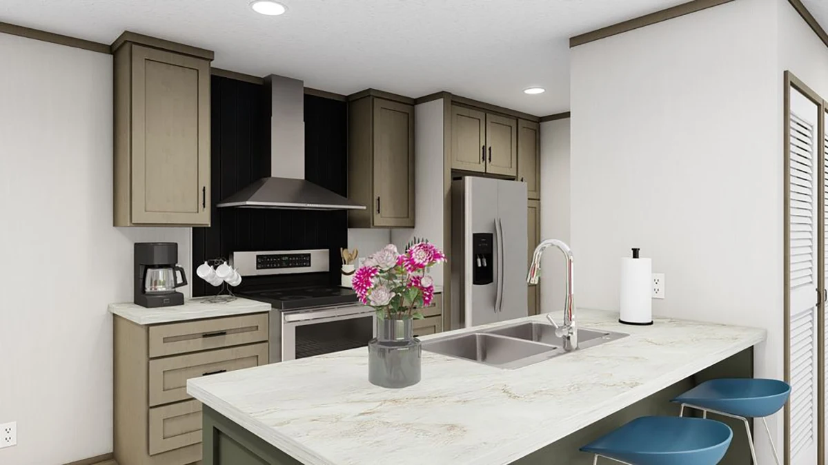 Modern kitchen with stainless steel appliances, beige cabinets, a center island with sink, two blue stools, and a vase of pink flowers on the countertop.