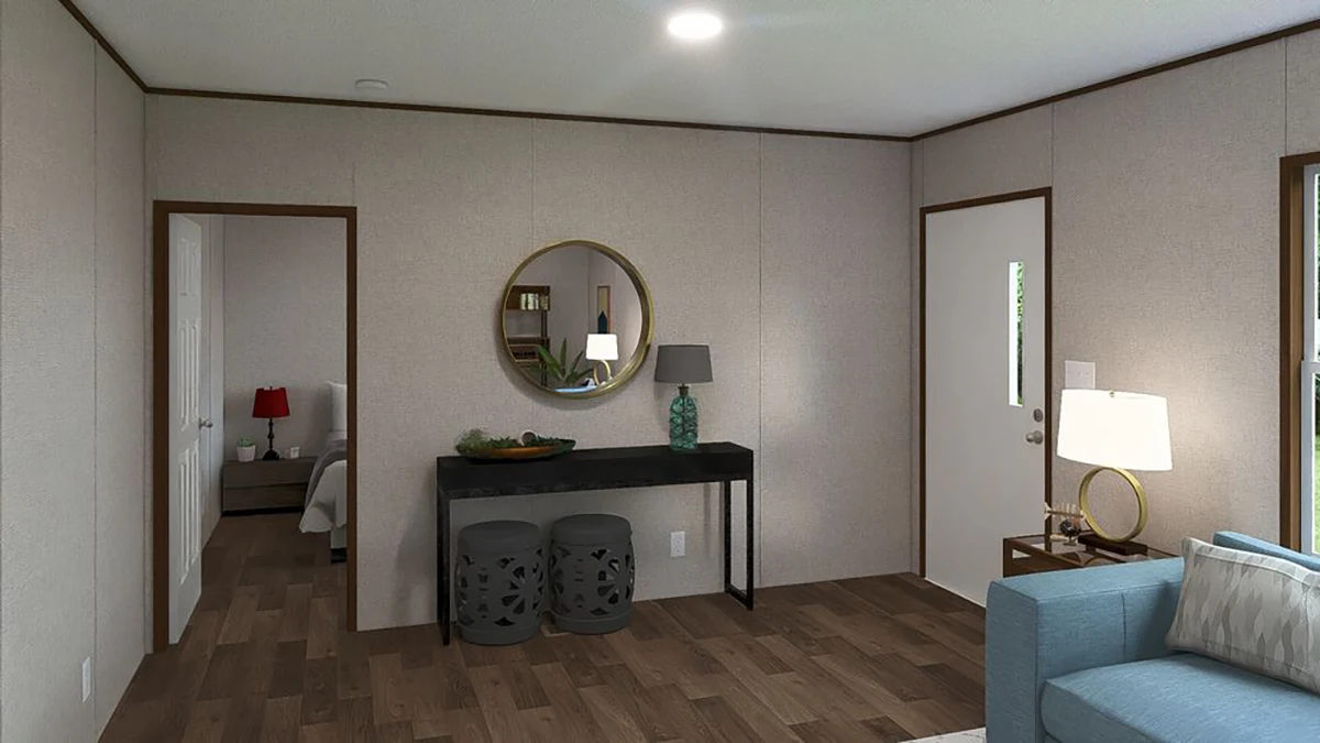 A living room with light walls, wood flooring, a console table with a round mirror, two stools, a lamp, and a sofa; doors lead to other rooms.