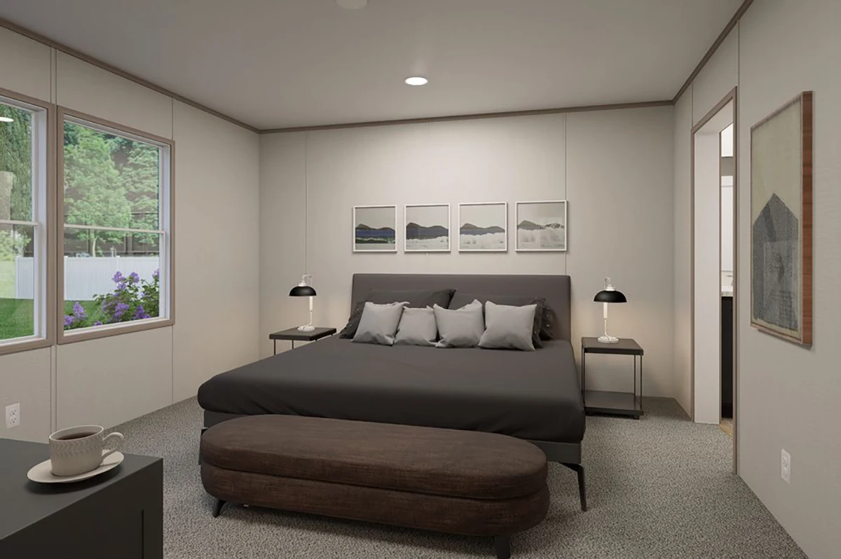 8f3a7742-1715-4bd2-a6fa-4de047f3d25a A modern bedroom with a dark bed, gray walls, a cushioned bench, side tables with lamps, framed artwork, and a window showing greenery outside.