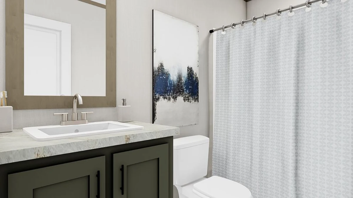 Modern bathroom with a sink, faucet, and mirror on the left, a toilet in the center, abstract artwork above it, and a shower with a patterned curtain on the right.
