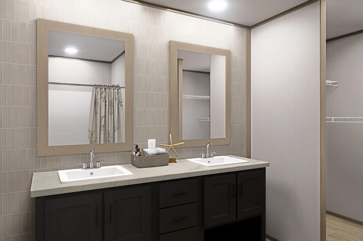Modern bathroom with two rectangular mirrors, double sinks, dark cabinetry, and light-colored tile walls. A basket and decorative items sit on the countertop.