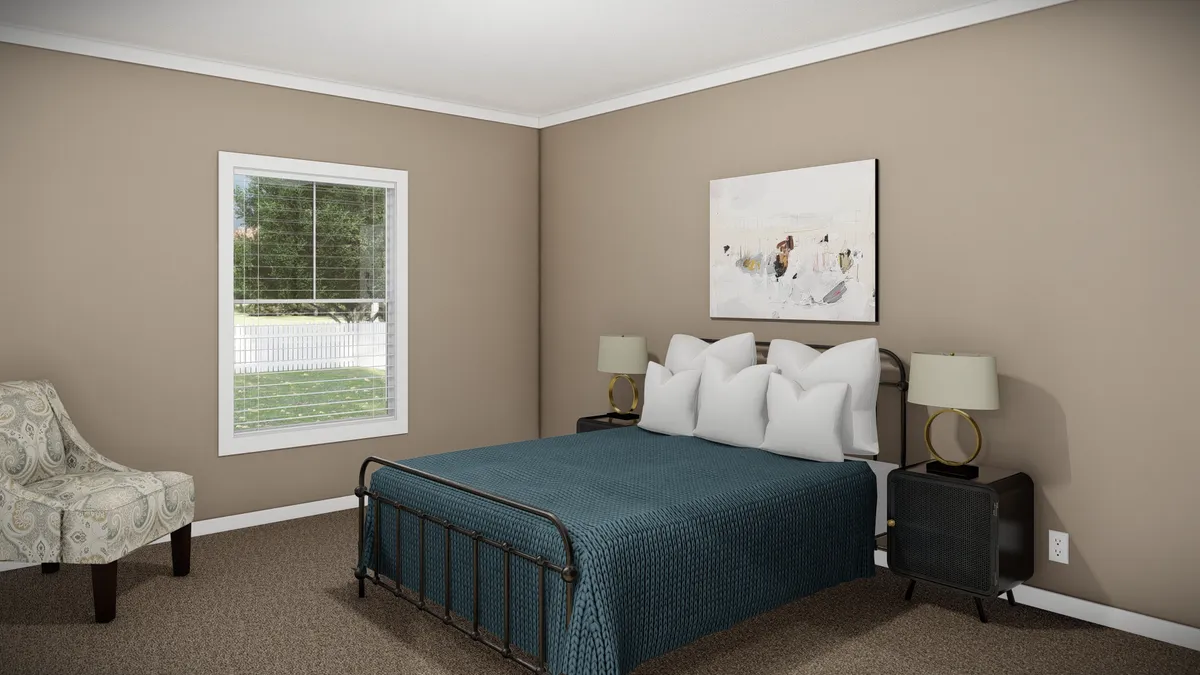 93343bb9-cead-4312-82ad-f09e45230cb5 A bedroom with a metal-frame bed, blue bedspread, two nightstands with lamps, a patterned armchair, and a window with blinds. A painting hangs above the bed.