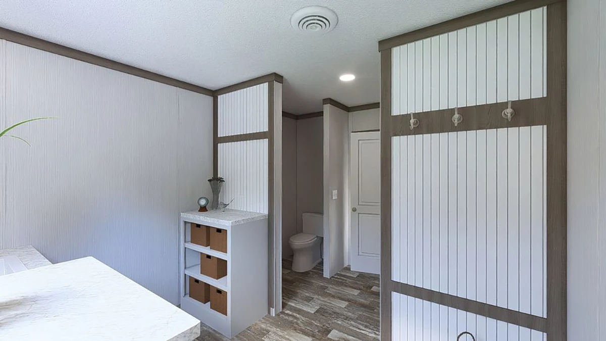 A modern bathroom with wood-look tile flooring, built-in storage cabinets, a countertop with baskets, and a separate area for the toilet.