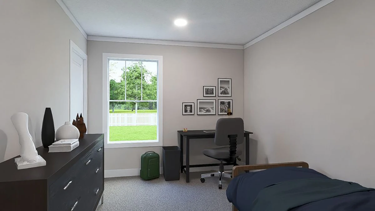 A simple bedroom with a bed, dresser, desk and chair, window with outdoor view, wall art, and various decor items on the dresser.