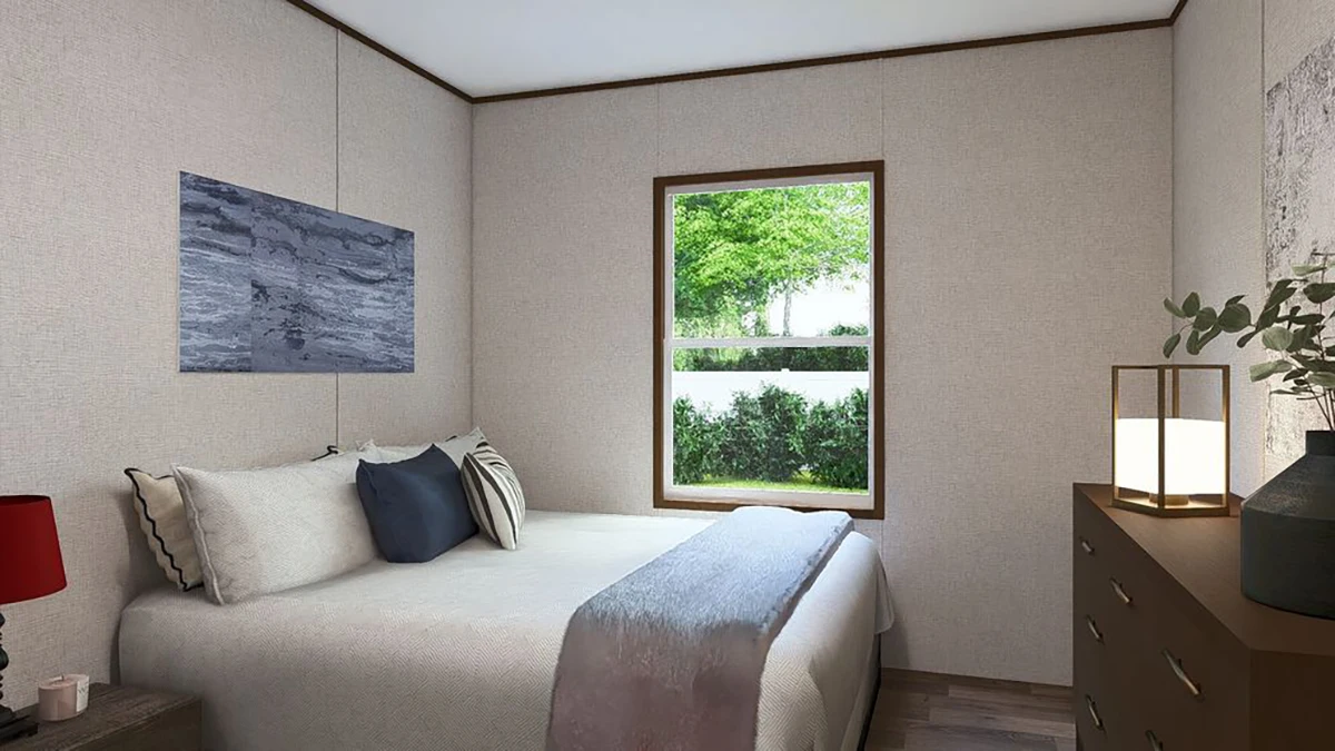 96e3aa49-eee4-4b01-ae5f-f9b660f1b161 A small bedroom with a neatly made bed, dresser with a lamp and plant, wall art above the bed, and a window showing greenery outside.